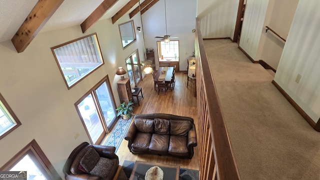 396 Greenleaf Dr, Lavonia, GA 30553 - living room featuring beamed ceiling, a towering ceiling, wood finished floors, baseboards, and a ceiling fan