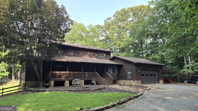 396 Greenleaf Dr, Lavonia, GA 30553 - view of front of home with covered porch, a garage, driveway, and stone siding