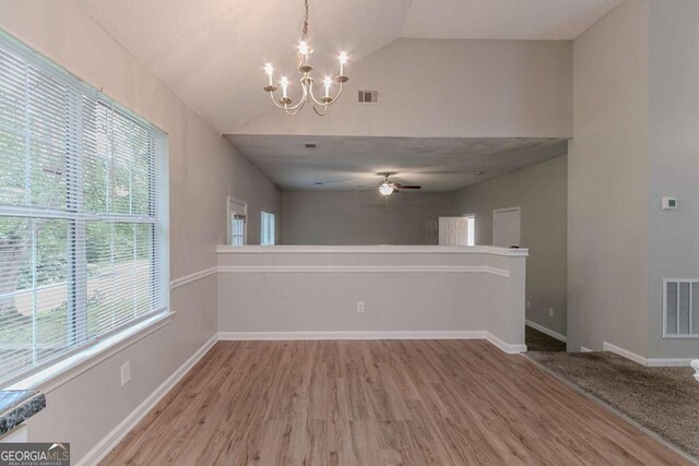 5421 Salem Springs Dr, Lithonia, GA 30038 - unfurnished dining area with lofted ceiling, wood finished floors, a chandelier, and ceiling fan