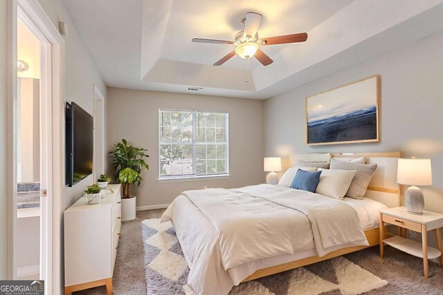 5421 Salem Springs Dr, Lithonia, GA 30038 - bedroom with a raised ceiling, light colored carpet, and ceiling fan