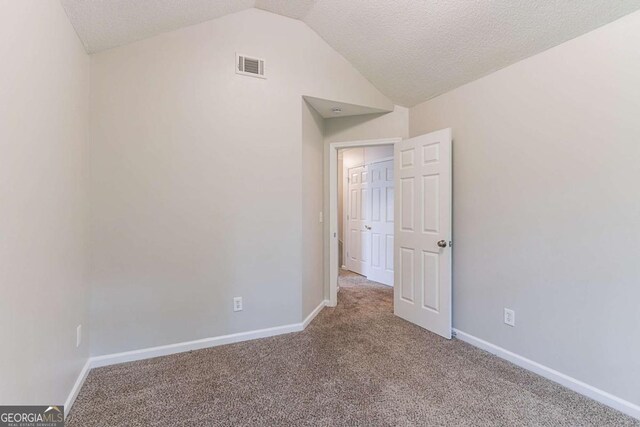 5421 Salem Springs Dr, Lithonia, GA 30038 - carpeted empty room featuring vaulted ceiling and a textured ceiling