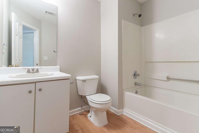 5421 Salem Springs Dr, Lithonia, GA 30038 - bathroom with wood finished floors, washtub / shower combination, and vanity