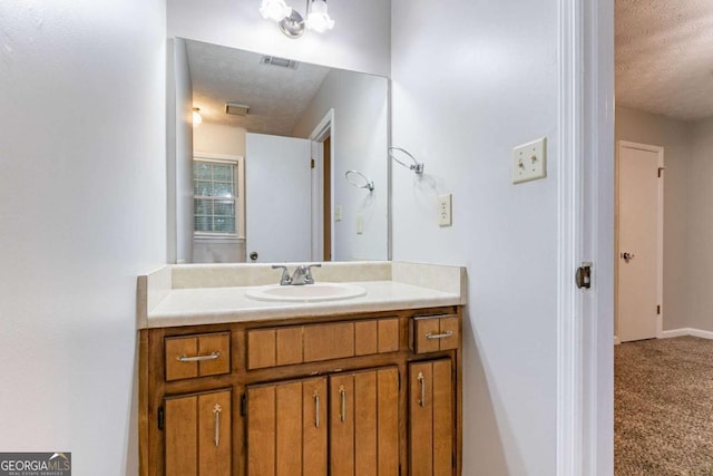 604 Hamlet Ct SE, Conyers, GA 30094 - bathroom featuring a textured ceiling and vanity