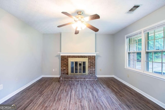 604 Hamlet Ct SE, Conyers, GA 30094 - unfurnished living room with wood finished floors, baseboards, a ceiling fan, and a fireplace