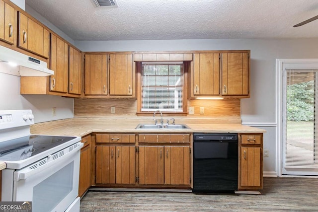604 Hamlet Ct SE, Conyers, GA 30094 - kitchen featuring black dishwasher, white range with electric stovetop, a sink, under cabinet range hood, and wood finished floors