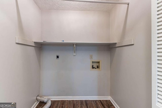 604 Hamlet Ct SE, Conyers, GA 30094 - laundry area featuring electric dryer hookup, hookup for a washing machine, dark wood-style flooring, baseboards, and a textured ceiling