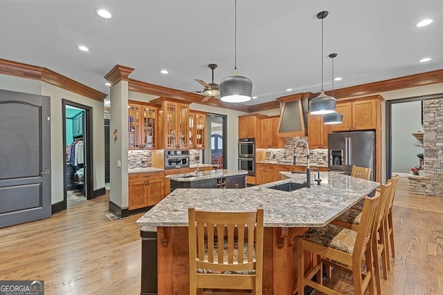2304 Weeping Oak Dr, Braselton, GA 30517 - kitchen with appliances with stainless steel finishes, a large island with sink, a sink, tasteful backsplash, and recessed lighting