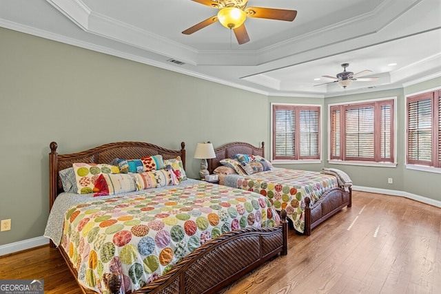 2304 Weeping Oak Dr, Braselton, GA 30517 - bedroom with a raised ceiling, wood-type flooring, crown molding, baseboards, and ceiling fan