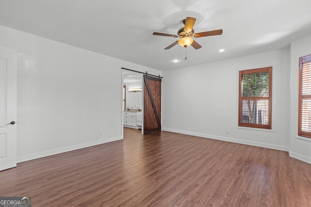2304 Weeping Oak Dr, Braselton, GA 30517 - unfurnished room featuring a barn door, dark wood-style flooring, a ceiling fan, recessed lighting, and baseboards