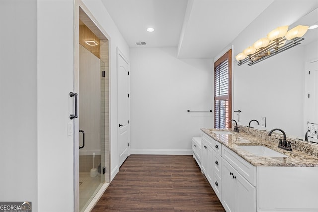 2304 Weeping Oak Dr, Braselton, GA 30517 - full bath with double vanity, a stall shower, wood finished floors, baseboards, and recessed lighting
