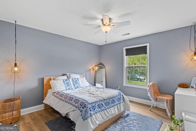 344 Mckibben Dr, Locust Grove, GA 30248 - bedroom with wood finished floors, baseboards, and ceiling fan
