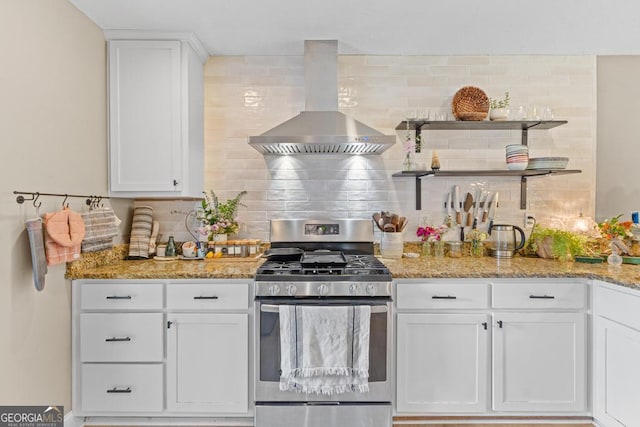 344 Mckibben Dr, Locust Grove, GA 30248 - kitchen featuring stainless steel range with gas cooktop, wall chimney range hood, tasteful backsplash, and white cabinetry