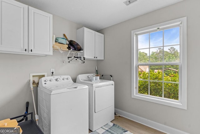 344 Mckibben Dr, Locust Grove, GA 30248 - washroom with cabinet space, washer and dryer, healthy amount of natural light, and light wood-style flooring