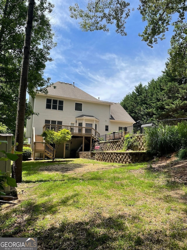 107 Sedgefield Overlook, Dallas, GA 30157 - back of property featuring stairway, a deck, and roof with shingles