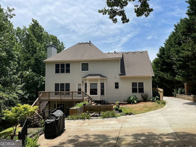 107 Sedgefield Overlook, Dallas, GA 30157 - back of house featuring stairs, a patio, a chimney, roof with shingles, and a deck