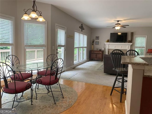 107 Sedgefield Overlook, Dallas, GA 30157 - dining room with light wood-style flooring, ceiling fan, a chandelier, and a fireplace