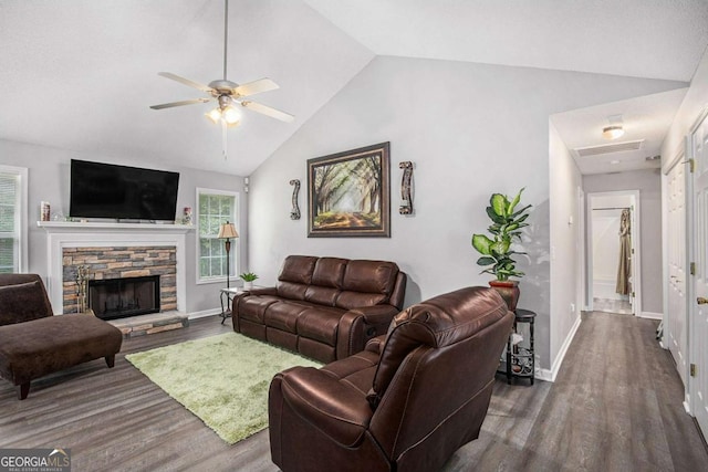 169 Winding Valley Dr, Rockmart, GA 30153 - living room featuring dark wood finished floors, ceiling fan, a stone fireplace, and high vaulted ceiling