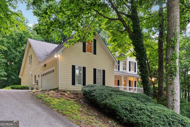 2722 Brookhaven Ln, Buford, GA 30518 - traditional-style home featuring a garage, covered porch, and a shingled roof
