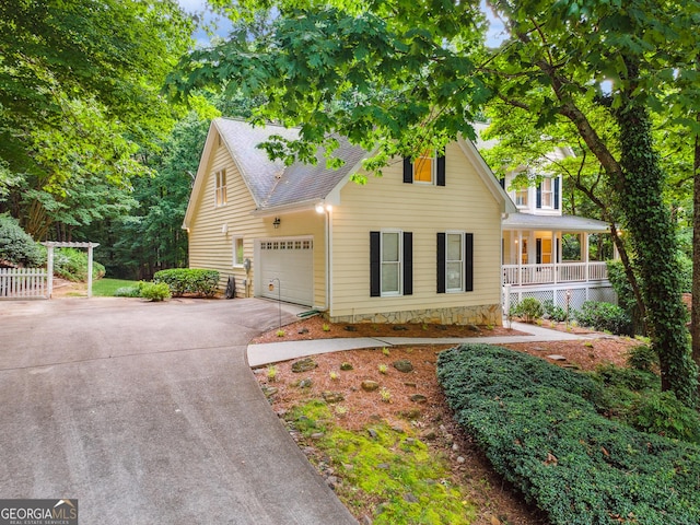 2722 Brookhaven Ln, Buford, GA 30518 - view of front of house featuring a shingled roof, concrete driveway, covered porch, and a garage