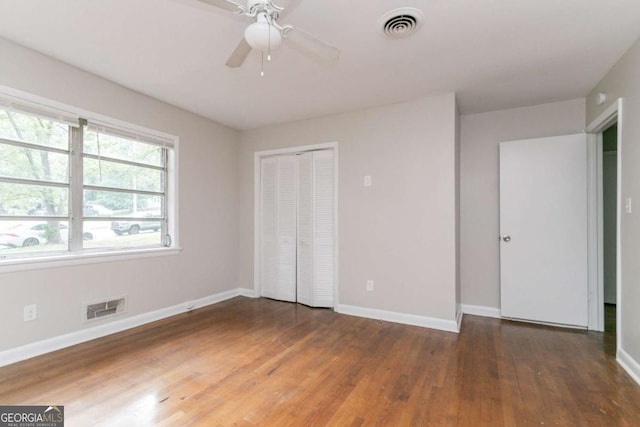 2582 Springdale Rd SW, Atlanta, GA 30315 - unfurnished bedroom with wood finished floors, baseboards, a closet, and a ceiling fan