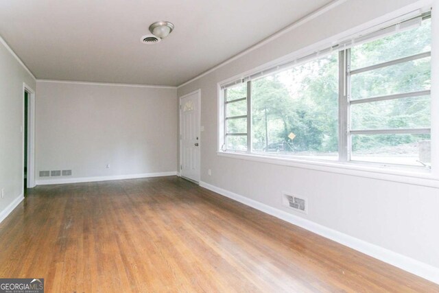 2582 Springdale Rd SW, Atlanta, GA 30315 - unfurnished room with crown molding, wood finished floors, and baseboards