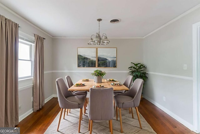 2582 Springdale Rd SW, Atlanta, GA 30315 - dining area featuring a chandelier, wood finished floors, baseboards, and crown molding