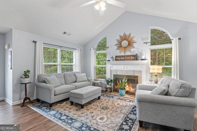320 Cobb Ct, Hampton, GA 30228 - living area featuring wood finished floors, ceiling fan, a tile fireplace, baseboards, and high vaulted ceiling