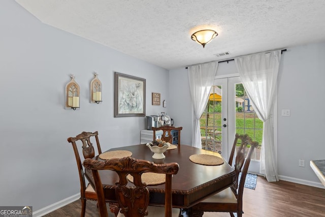 320 Cobb Ct, Hampton, GA 30228 - dining space with baseboards, wood finished floors, french doors, and a textured ceiling