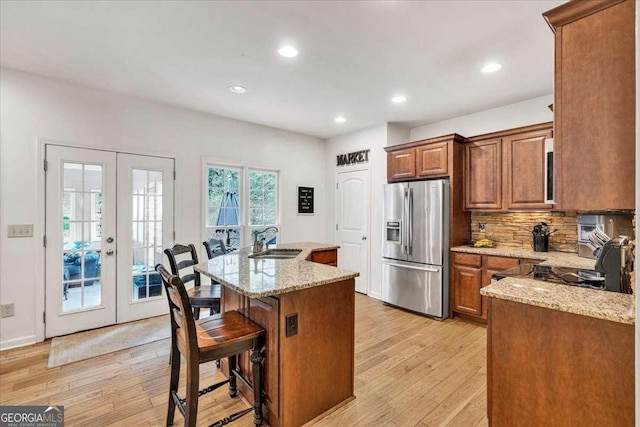 1637 Willow Way, Woodstock, GA 30188 - kitchen with stainless steel fridge with ice dispenser, a sink, french doors, light wood-type flooring, and backsplash