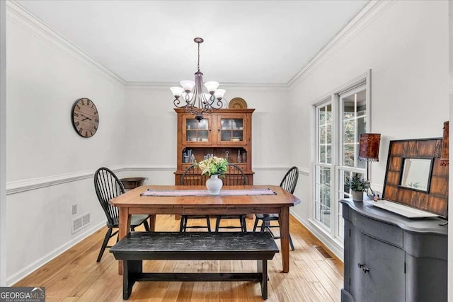 1637 Willow Way, Woodstock, GA 30188 - dining room with a chandelier, crown molding, light wood finished floors, and baseboards