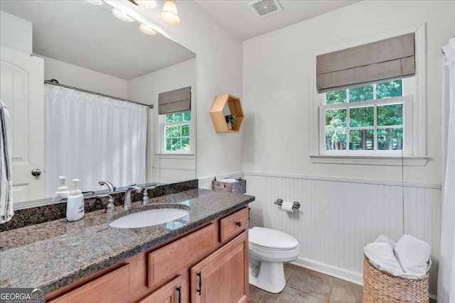 1637 Willow Way, Woodstock, GA 30188 - bathroom with toilet, vanity, wainscoting, tile patterned floors, and curtained shower