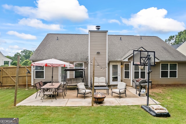 5511 Preserve Pt, Flowery Branch, GA 30542 - back of house featuring an outdoor living space with a fire pit, a patio area, roof with shingles, and a chimney