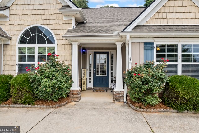 5511 Preserve Pt, Flowery Branch, GA 30542 - view of exterior entry featuring a shingled roof and board and batten siding