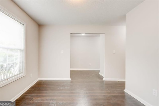 7006 Mahonia Pl, Lithonia, GA 30038 - empty room with wood finished floors, baseboards, and a textured ceiling