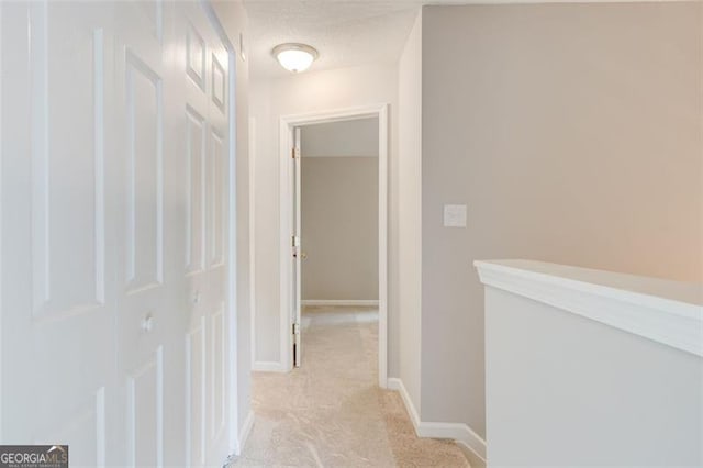 7006 Mahonia Pl, Lithonia, GA 30038 - hallway featuring light colored carpet, a textured ceiling, and baseboards