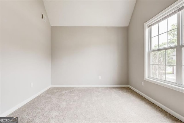 7006 Mahonia Pl, Lithonia, GA 30038 - spare room featuring lofted ceiling, carpet, and baseboards