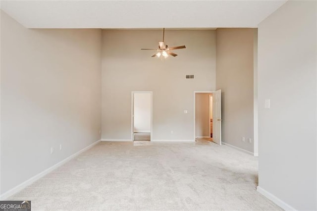 7006 Mahonia Pl, Lithonia, GA 30038 - unfurnished room with ceiling fan, light colored carpet, a towering ceiling, and baseboards