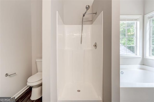 7006 Mahonia Pl, Lithonia, GA 30038 - bathroom featuring toilet, a bath, a shower, and baseboards