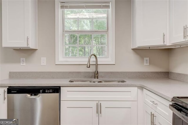 7006 Mahonia Pl, Lithonia, GA 30038 - kitchen featuring stainless steel dishwasher, a sink, white cabinetry, and light countertops