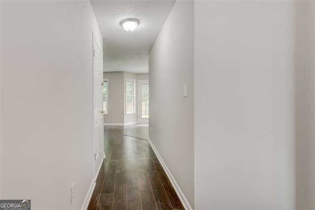 7006 Mahonia Pl, Lithonia, GA 30038 - corridor featuring dark wood-type flooring, baseboards, and a textured ceiling