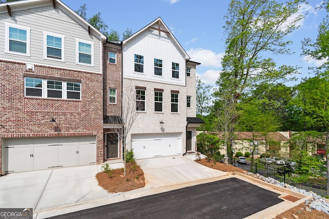 586 Avondale Park Cir Unit 51, Decatur, GA 30032 - view of front of home featuring concrete driveway, an attached garage, and brick siding
