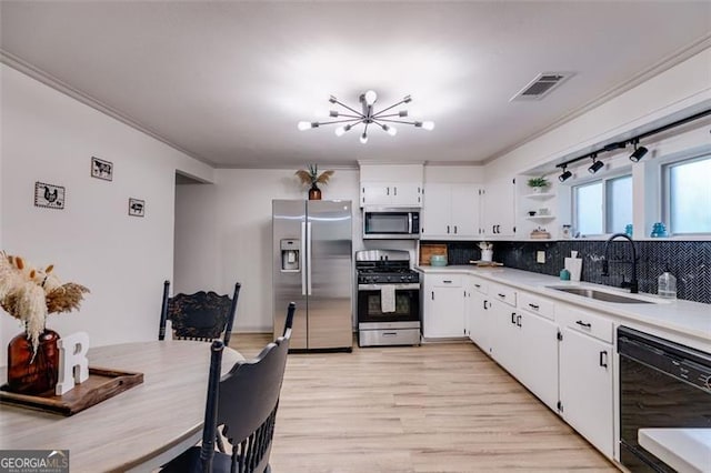 394 Knight Rd, Rockmart, GA 30153 - kitchen featuring appliances with stainless steel finishes, a sink, open shelves, light countertops, and backsplash