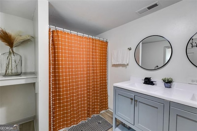 394 Knight Rd, Rockmart, GA 30153 - bathroom featuring double vanity, a shower with shower curtain, and wood finished floors