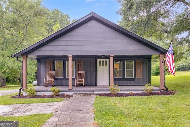 394 Knight Rd, Rockmart, GA 30153 - bungalow featuring covered porch, a front yard, and board and batten siding