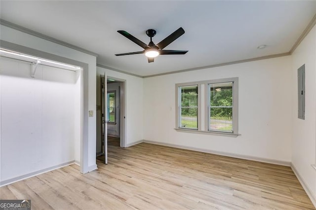 394 Knight Rd, Rockmart, GA 30153 - unfurnished bedroom with ornamental molding, electric panel, light wood-style flooring, baseboards, and ceiling fan