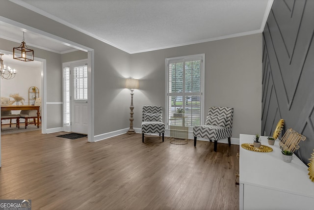2715 N Doublegate Dr, Albany, GA 31721 - living area featuring wood finished floors, a chandelier, and crown molding