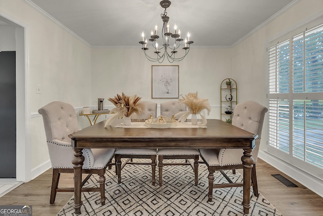 2715 N Doublegate Dr, Albany, GA 31721 - dining area with a chandelier, wood finished floors, and crown molding