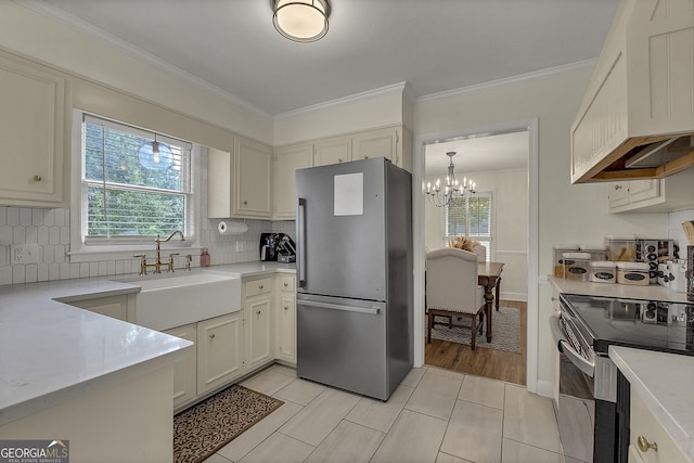 2715 N Doublegate Dr, Albany, GA 31721 - kitchen featuring freestanding refrigerator, electric stove, healthy amount of natural light, light countertops, and crown molding