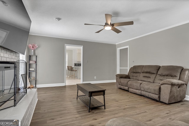 2715 N Doublegate Dr, Albany, GA 31721 - living area with ceiling fan, ornamental molding, wood finished floors, and a brick fireplace