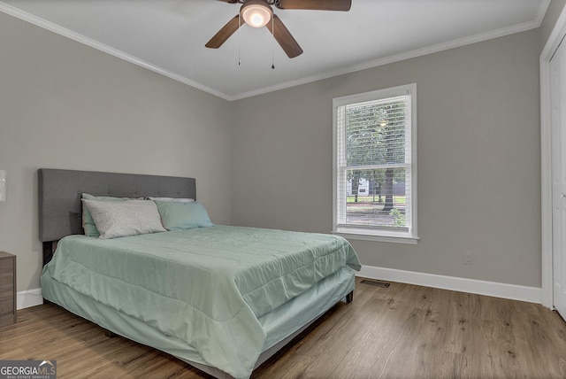 2715 N Doublegate Dr, Albany, GA 31721 - bedroom with wood finished floors, ornamental molding, and ceiling fan